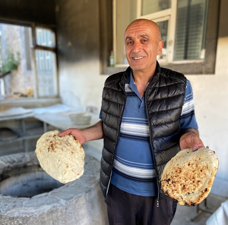 Armenian man holding loshik (Armenian bread)