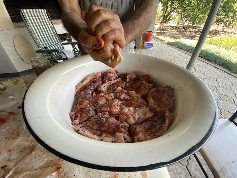 squeezing the onion juice on Armenian BBQ